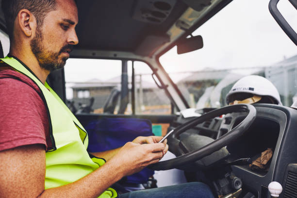 istockphoto-1054724792-612×612 SydneyConstruction.
Construction industry worker texting on the phone inside a truck.